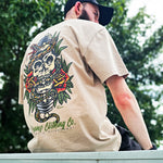 Back shot of Omenz Alternative Athletic Streetwear Strike Hard Unisex Oversized Tee in 100% premium cotton and a faded khaki. Snake and skull print design.