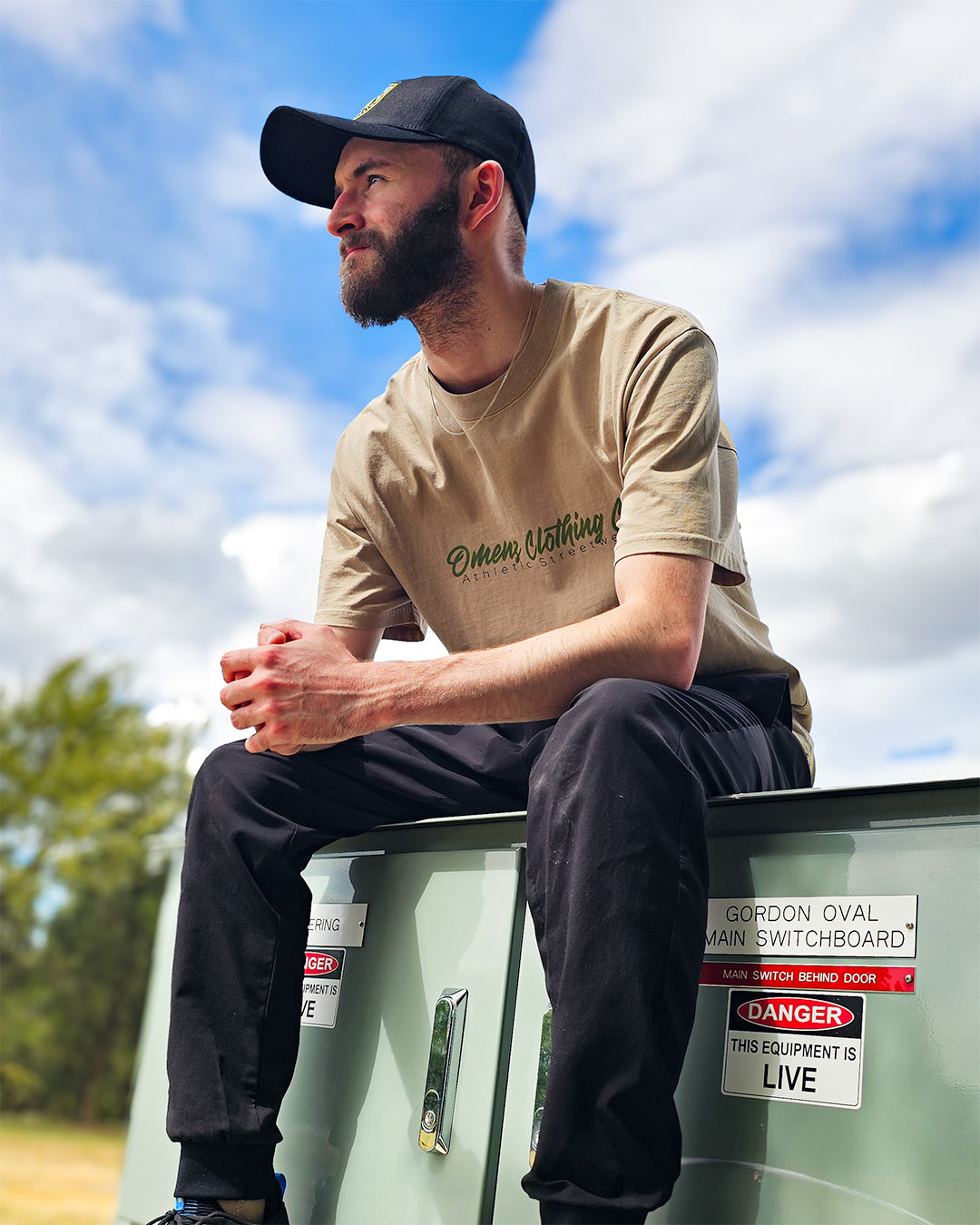 Front image Omenz Alternative Athletic Streetwear Strike Hard Unisex Oversized Tee in 100% premium cotton and a faded khaki. Snake and skull print design, designed in Australia.