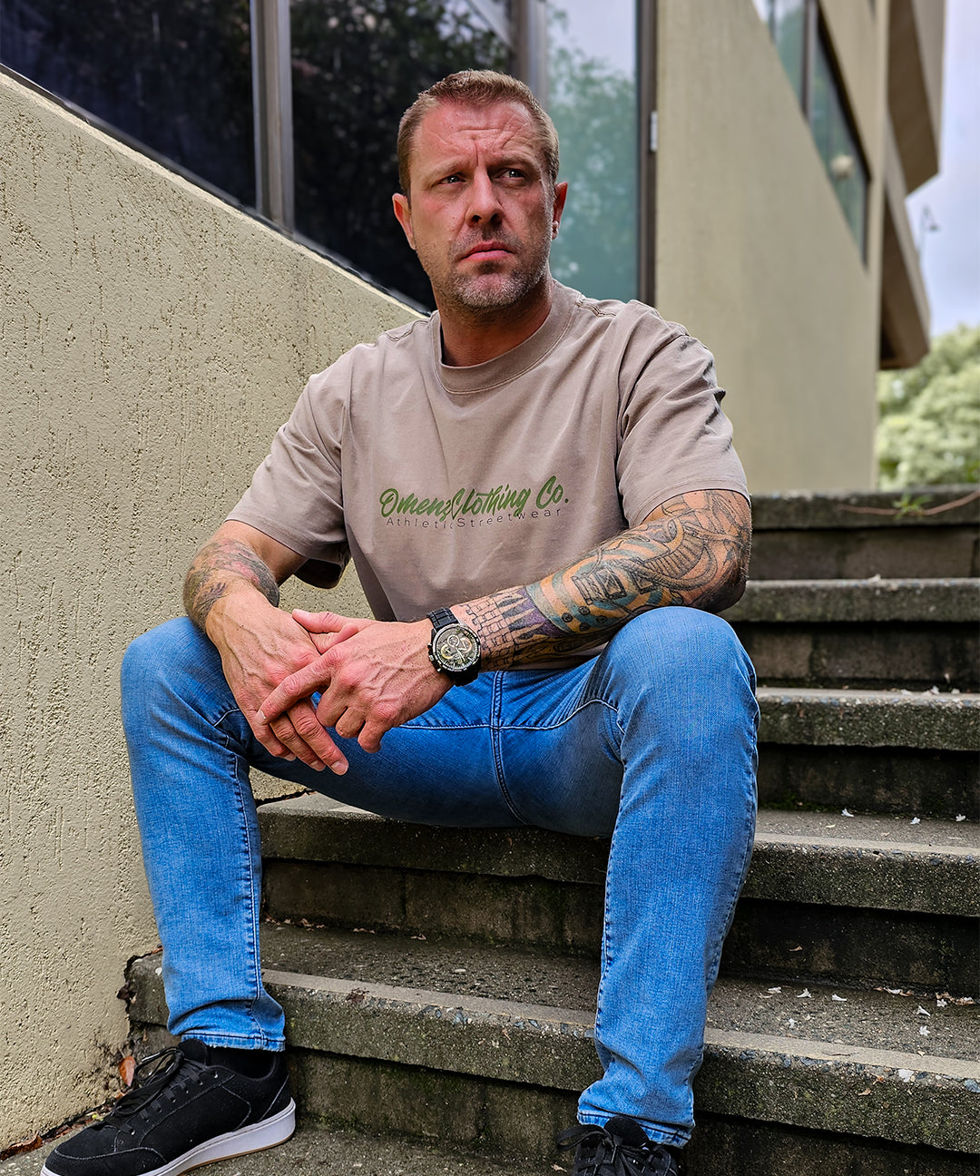 Front image Omenz Alternative Athletic Streetwear Strike Hard Unisex Oversized Tee in 100% premium cotton and a faded khaki.