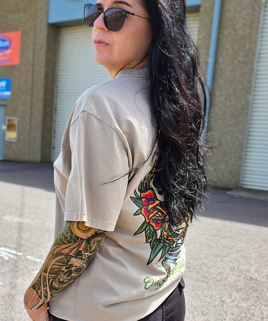 Omenz alternative streetwear tee – oversized premium cotton t-shirt worn with tattooed arm visible. Printed in Australia.