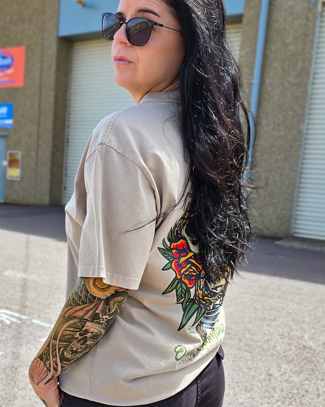 Omenz alternative streetwear tee – oversized premium cotton t-shirt worn with tattooed arm visible. Printed in Australia.